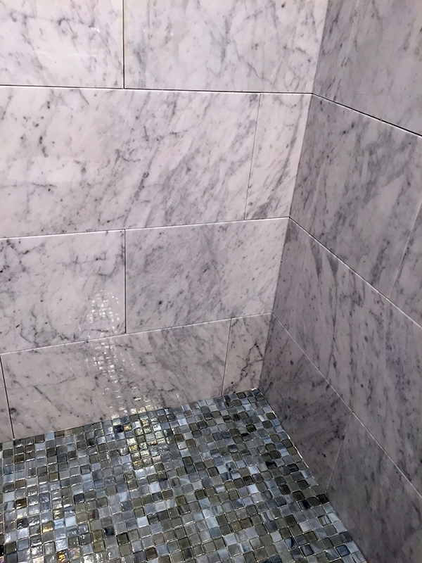 Marble shower with glass tile floor Marble shower with glass tile floor