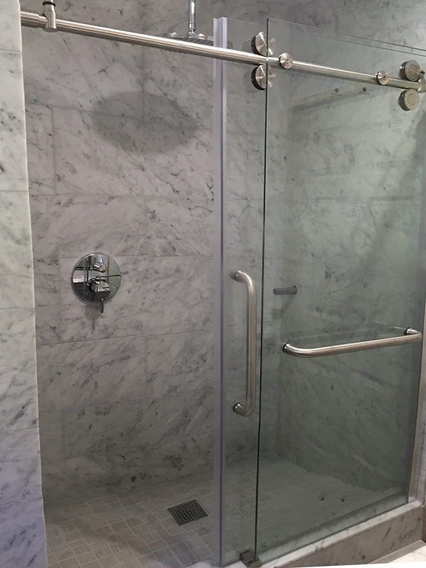 Marble tile shower with glass sliding door Marble tile shower with glass sliding door