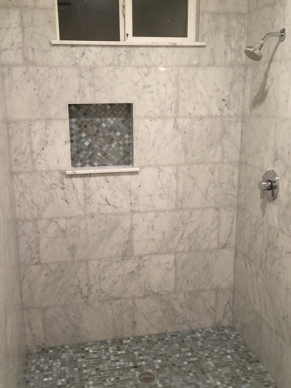 Marble tile shower and mosaic glass tile floor Marble tile shower and mosaic glass tile floor