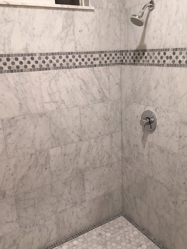 Marble tile shower with mosaic boarder and flooring Marble tile shower with mosaic boarder and flooring